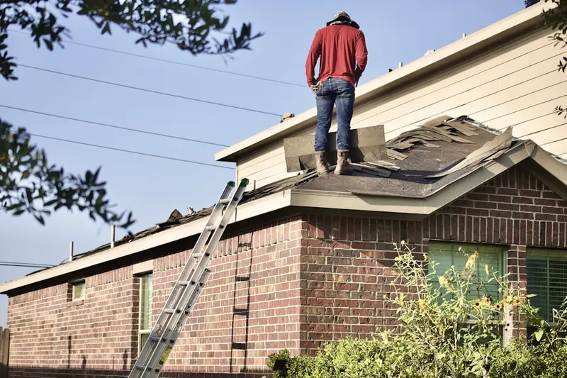 Professional roofer working on a residential roof in Downtown Lowell